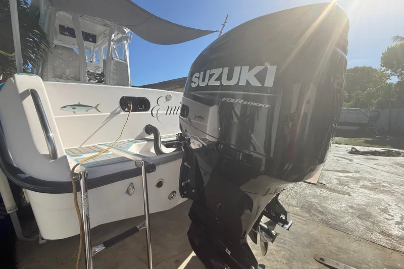 Slide: The Image of 1996 Grady-White Sailfish 272 with Suzuki four-stroke outboard motor in sunny outdoor setting. - 21