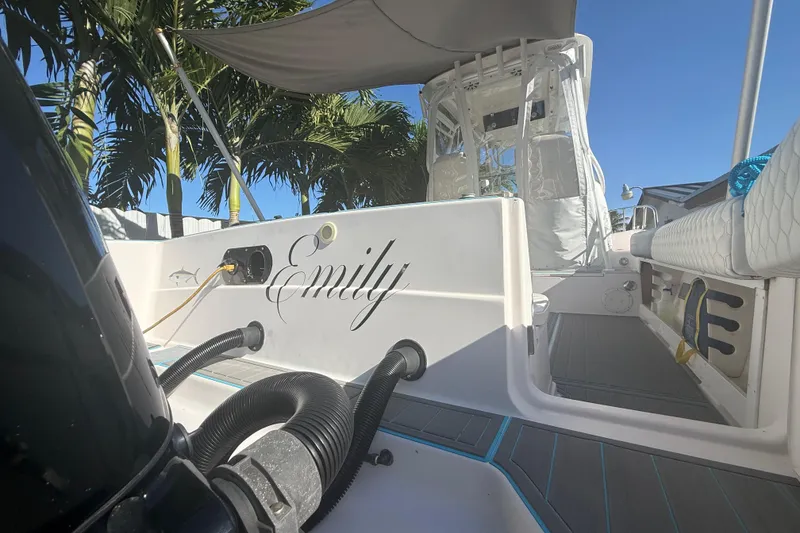 Slide: The Image of 1996 Grady-White Sailfish 272 boat named "Emily" docked under palm trees. - 24