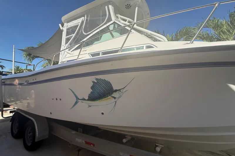 Slide: The Image of 1996 Grady-White Sailfish 272 boat with sailfish graphic, parked on trailer. - 3
