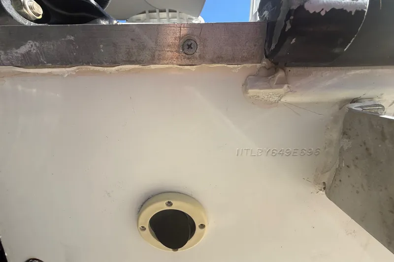 Slide: The Image of Close-up of 1996 Grady-White Sailfish 272 hull with visible serial number and metal fittings. - 30