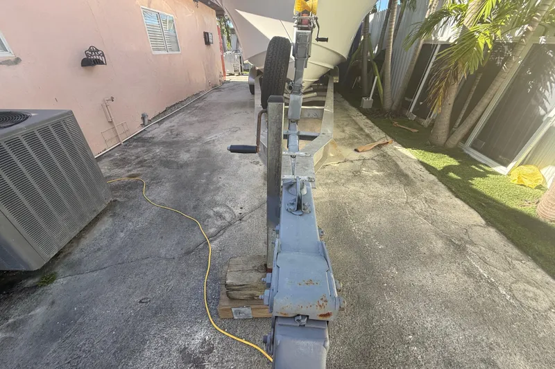 Slide: The Image of Boat trailer for 1996 Grady-White Sailfish 272 parked on concrete driveway. - 34