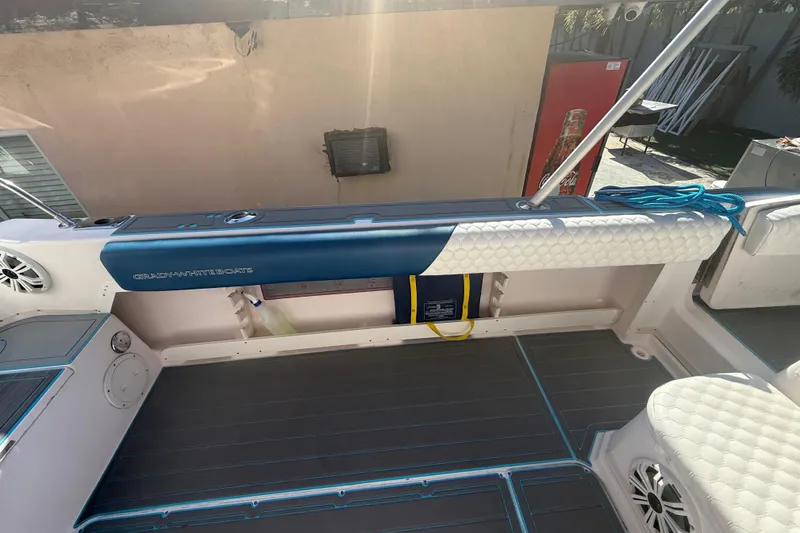 Slide: The Image of 1996 Grady-White Sailfish 272 boat interior with cushioned seating and marine speakers. - 37