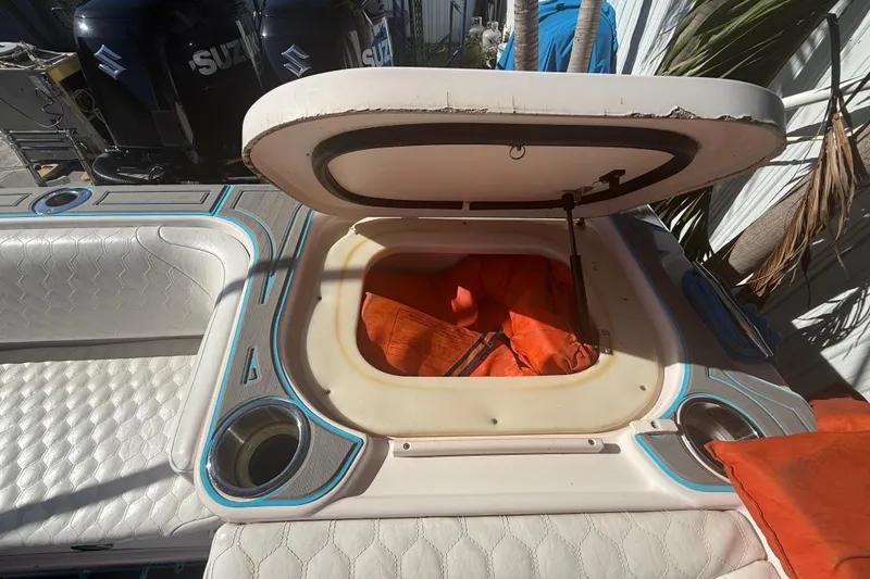 Slide: The Image of Open storage compartment on 1996 Grady-White Sailfish 272 boat with orange life jackets. - 39