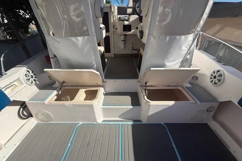 Slide: The Image of 1996 Grady-White Sailfish 272 boat interior with open storage compartments and seating. - 41