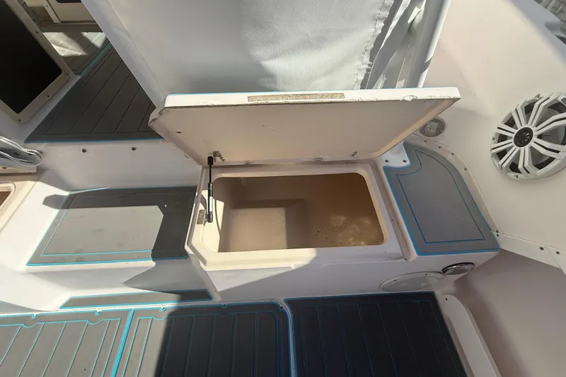 Slide: The Image of Open storage compartment on 1996 Grady-White Sailfish 272 boat deck, featuring marine speaker. - 42