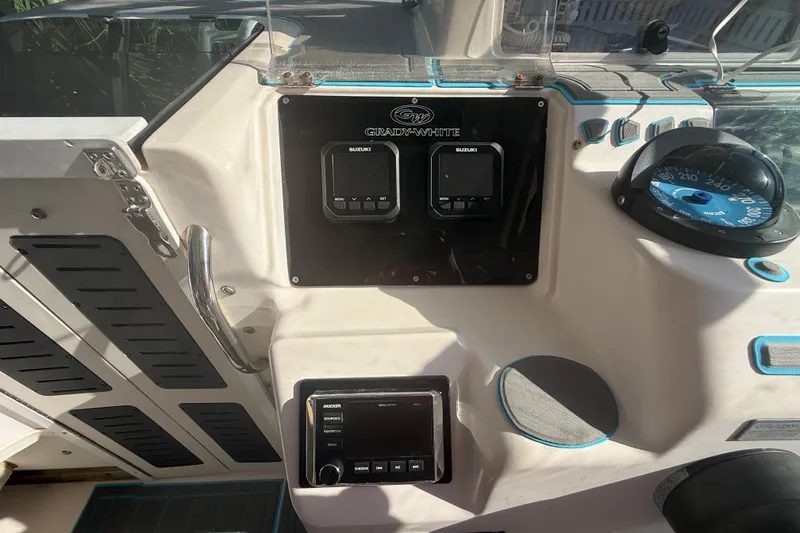 Slide: The Image of Control panel of a 1996 Grady-White Sailfish 272 boat with Suzuki displays. - 48