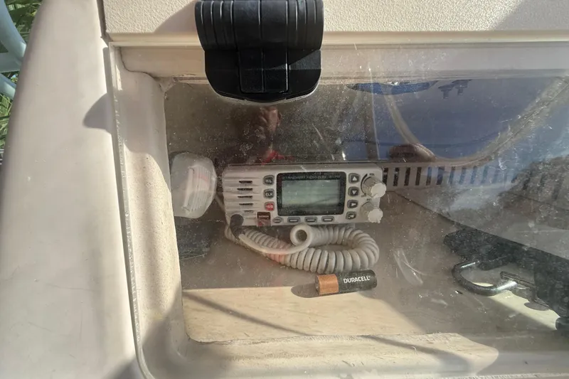 Slide: The Image of 1996 Grady-White Sailfish 272 boat radio compartment with visible electronics and battery. - 51