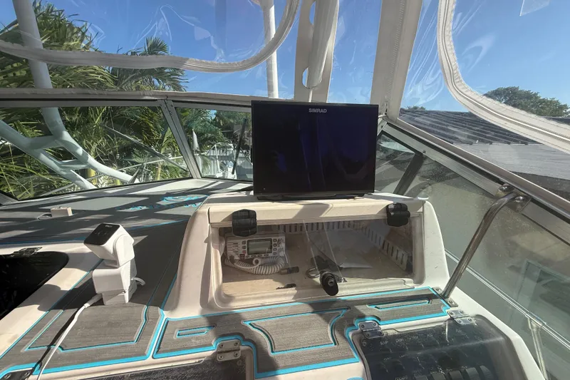 Slide: The Image of 1996 Grady-White Sailfish 272 helm with Simrad display and navigation equipment. - 56