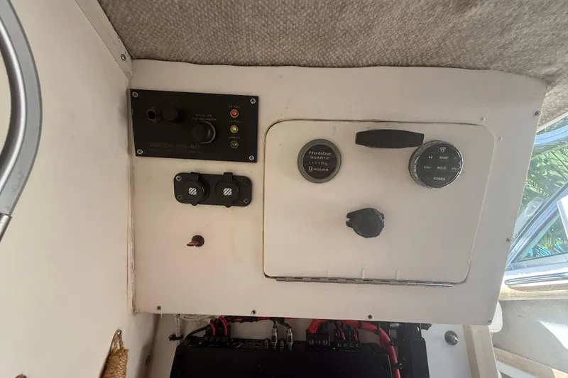 Slide: The Image of Control panel of a 1996 Grady-White Sailfish 272 boat, featuring gauges and switches. - 58