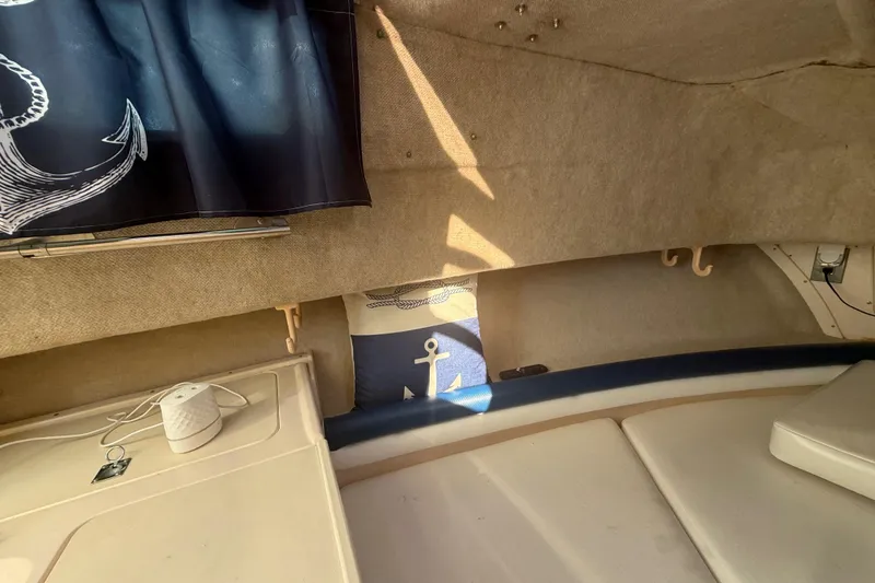 Slide: The Image of Interior of 1996 Grady-White Sailfish 272 boat with nautical decor and seating. - 62