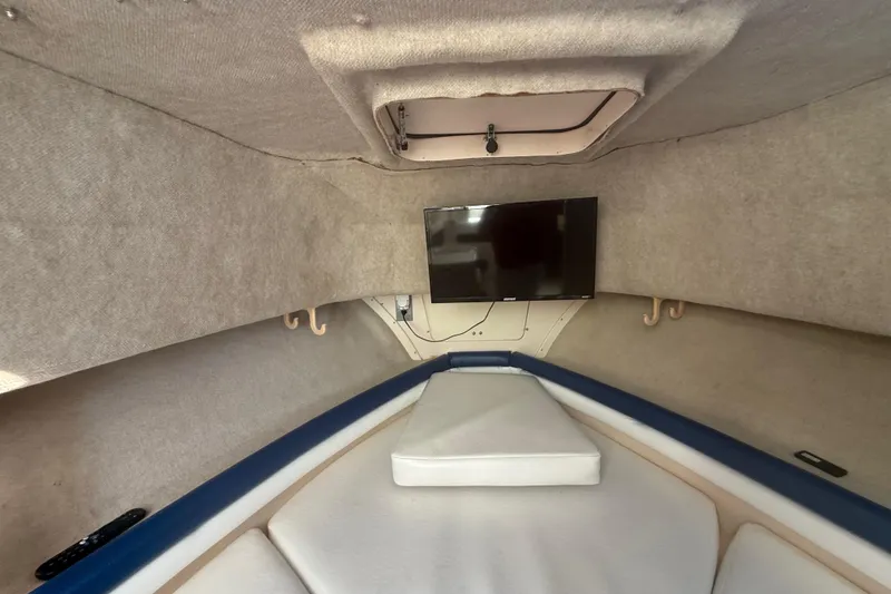 Slide: The Image of Interior cabin of 1996 Grady-White Sailfish 272 with TV and cushioned seating. - 64