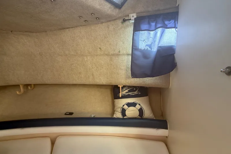 Slide: The Image of 1996 Grady-White Sailfish 272 cabin interior with nautical-themed decor and window curtain. - 66