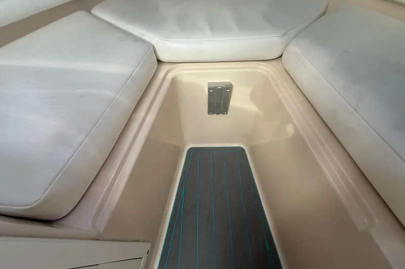 Slide: The Image of Interior view of a 1996 Grady-White Sailfish 272 boat with cushioned seating. - 67