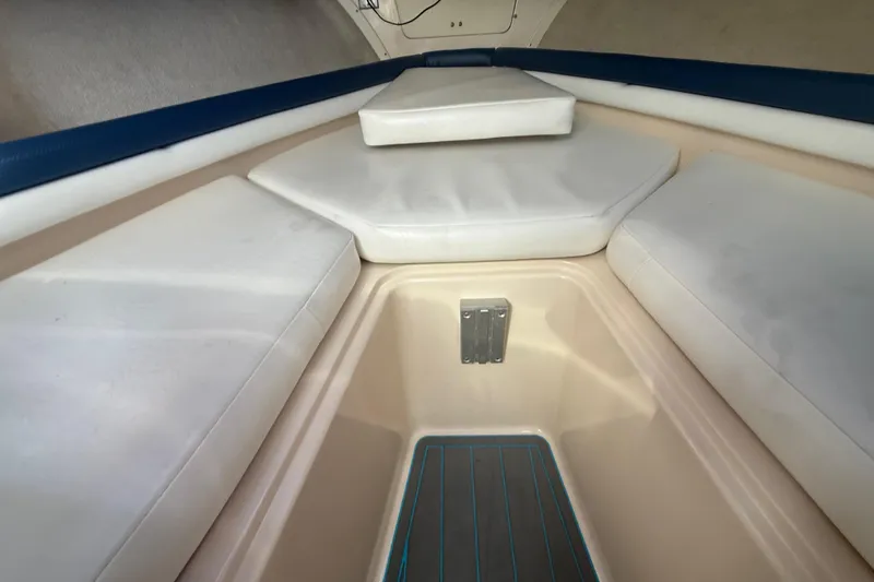 Slide: The Image of Interior cabin of 1996 Grady-White Sailfish 272 with cushioned seating and storage area. - 68