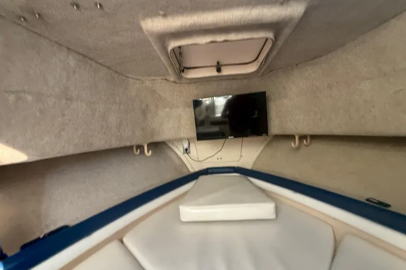 Slide: The Image of 1996 Grady-White Sailfish 272 cabin interior with TV and cushioned seating. - 70
