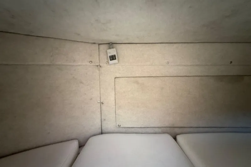 Slide: The Image of Interior cabin of 1996 Grady-White Sailfish 272 boat, featuring cushioned seating. - 73