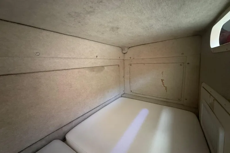 Slide: The Image of Interior cabin of 1996 Grady-White Sailfish 272 boat, featuring beige upholstery. - 74