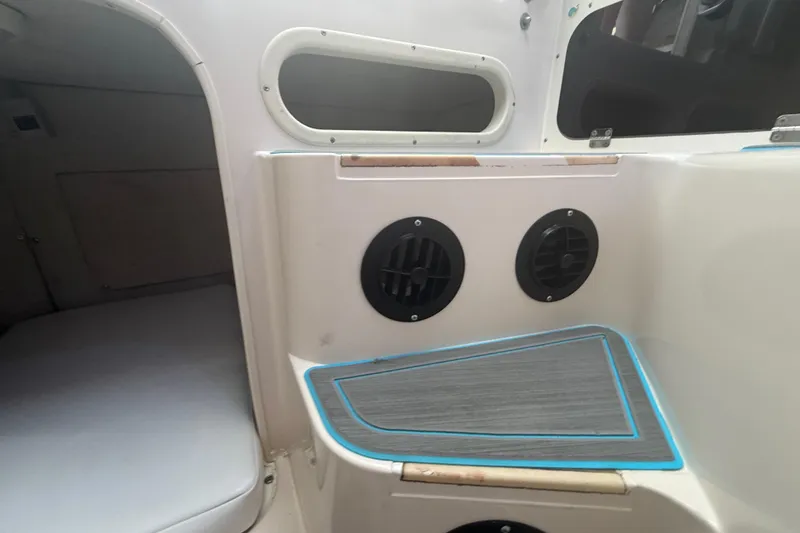 Slide: The Image of Interior of a 1996 Grady-White Sailfish 272 boat, featuring cabin seating and ventilation. - 75