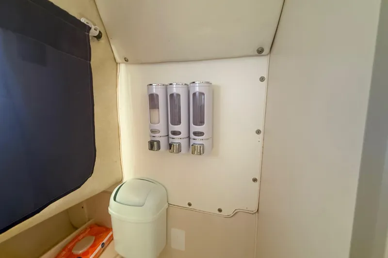 Slide: The Image of Wall-mounted dispensers and trash bin in 1996 Grady-White Sailfish 272 boat interior. - 76