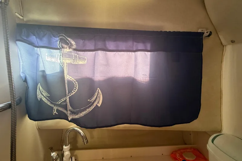 Slide: The Image of Curtained window with anchor design in 1996 Grady-White Sailfish 272 boat interior. - 77
