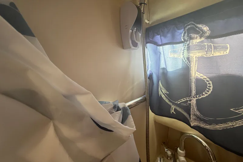 Slide: The Image of Nautical-themed bathroom in 1996 Grady-White Sailfish 272 boat with anchor curtain. - 78