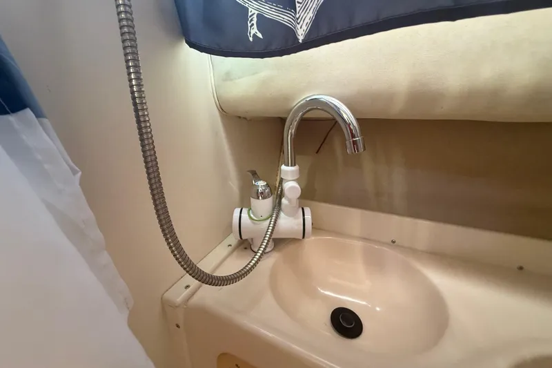 Slide: The Image of Bathroom sink with chrome faucet in 1996 Grady-White Sailfish 272 boat. - 79