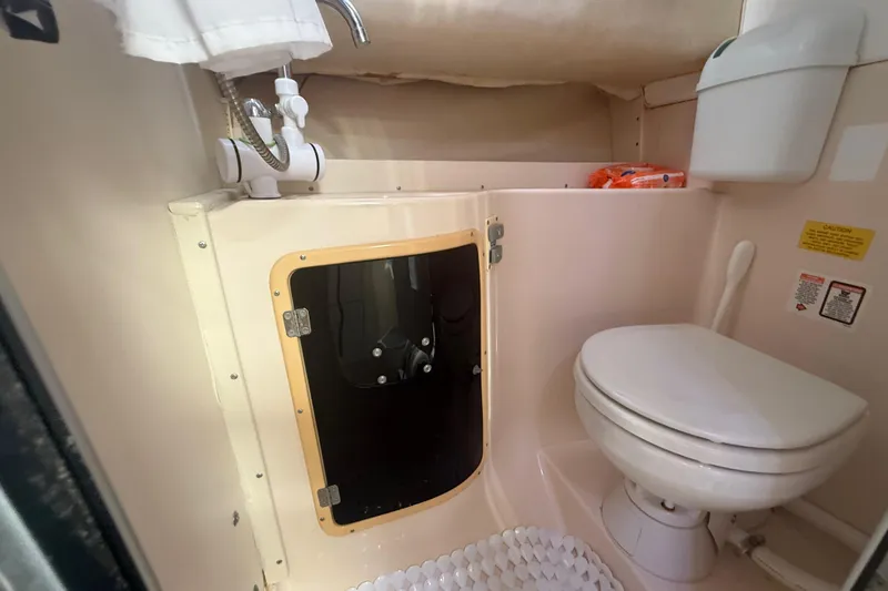 Slide: The Image of 1996 Grady-White Sailfish 272 boat bathroom with toilet and sink. - 80