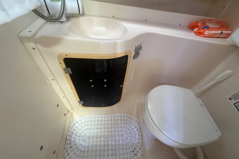 Slide: The Image of 1996 Grady-White Sailfish 272 boat bathroom with sink, toilet, and storage compartment. - 81