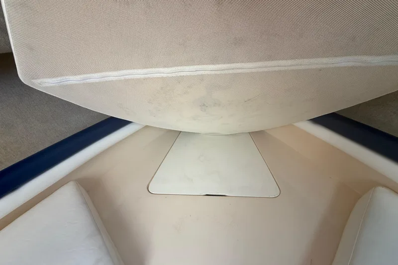 Slide: The Image of Interior view of a 1996 Grady-White Sailfish 272 boat cabin with cushioned seating. - 86
