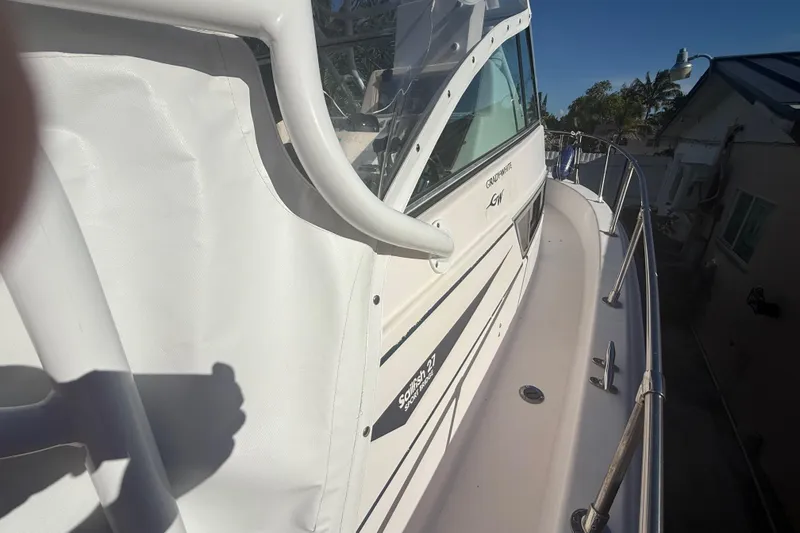 Slide: The Image of 1996 Grady-White Sailfish 272 boat side view with railing and cabin details. - 89