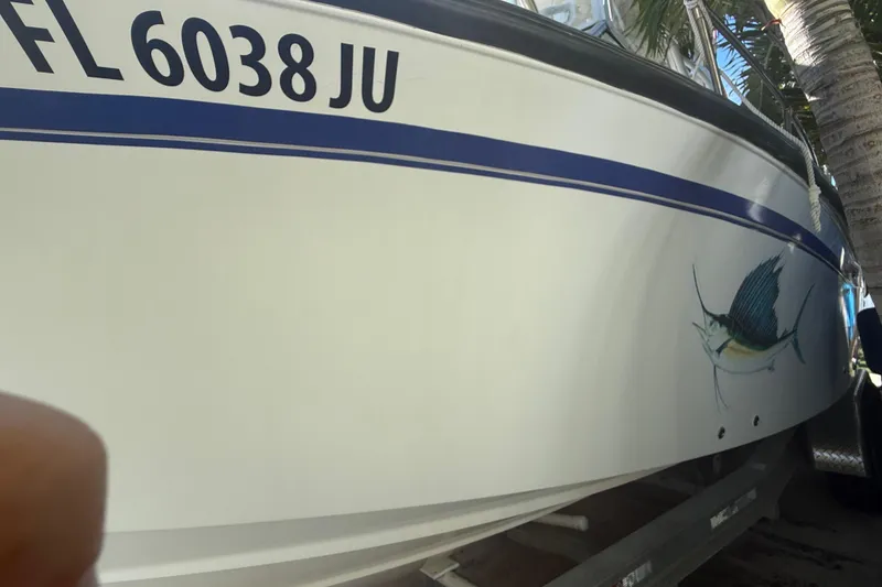 Slide: The Image of 1996 Grady-White Sailfish 272 boat with sailfish graphic and registration number FL 6038 JU. - 9