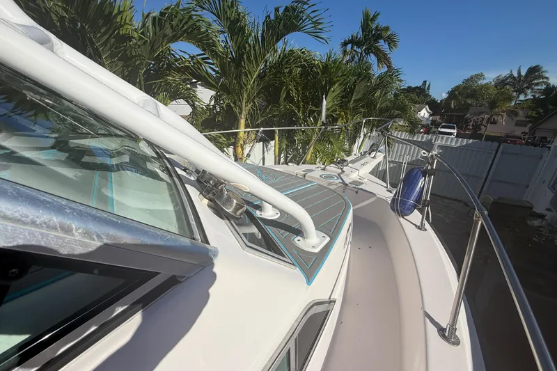 Slide: The Image of 1996 Grady-White Sailfish 272 boat docked, surrounded by lush palm trees. - 92