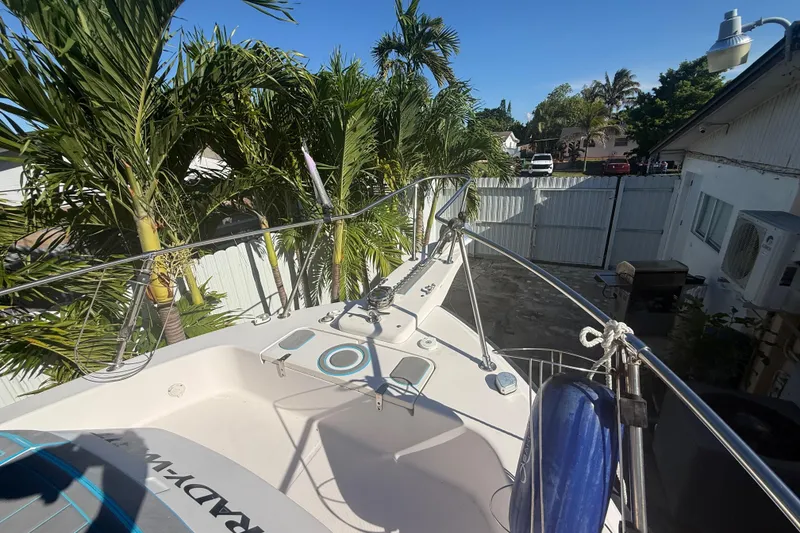 Slide: The Image of 1996 Grady-White Sailfish 272 boat docked near palm trees in a residential area. - 94