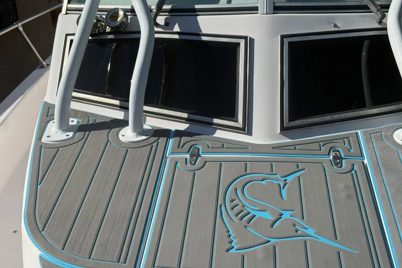 Slide: The Image of 1996 Grady-White Sailfish 272 boat deck with marlin design and sturdy railings. - 98