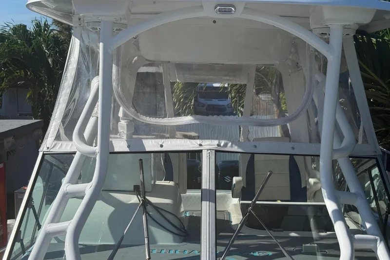 Slide: The Image of 1996 Grady-White Sailfish 272 boat with enclosed cockpit and windshield wipers. - 99