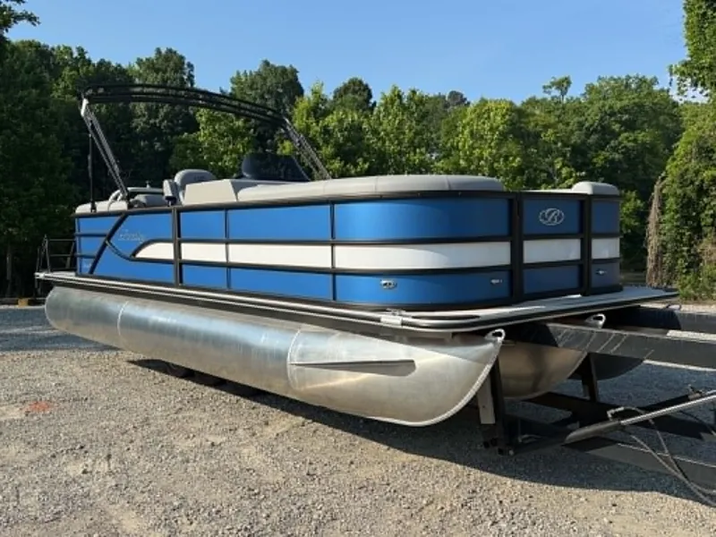 The Image of 2026 Bentley Pontoons Legacy 223 Navigator on trailer, blue design. - 1