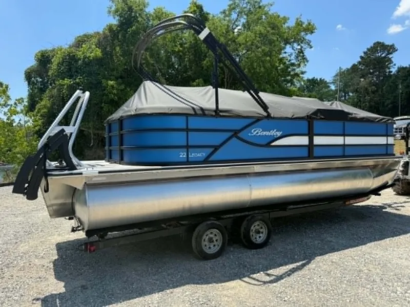 Slide: The Image of 2026 Bentley Pontoons Legacy 223 Navigator on trailer, blue and black. - 23