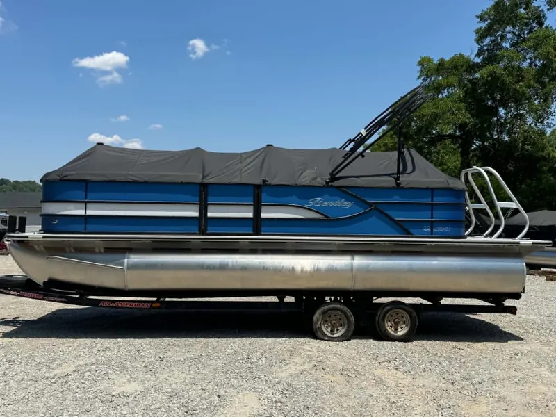 Slide: The Image of 2026 Bentley Pontoons Legacy 223 Navigator on trailer, blue sky. - 5