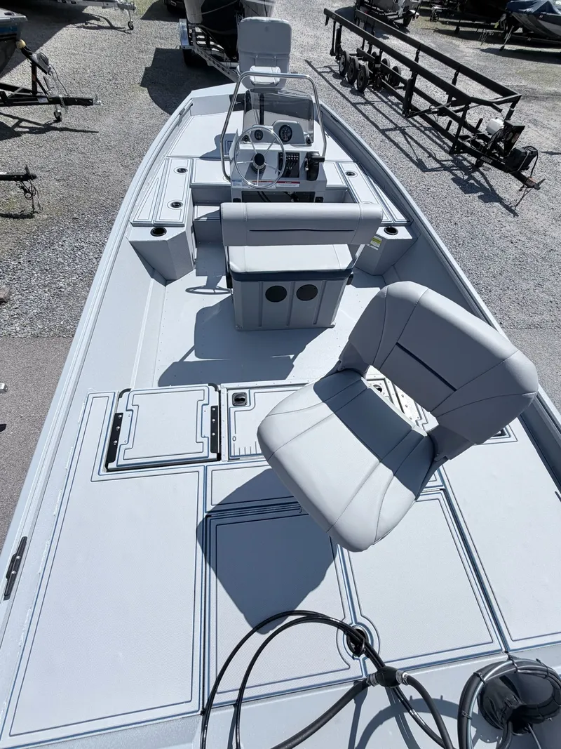 Slide: The Image of 2026 G3 Gator Tough 20CCJ DLX boat with gray seats and steering console. - 3
