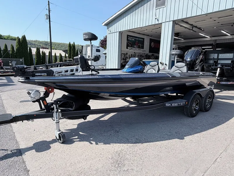Slide: The Image of 2022 Skeeter ZX200 boat on trailer outside workshop. - 26