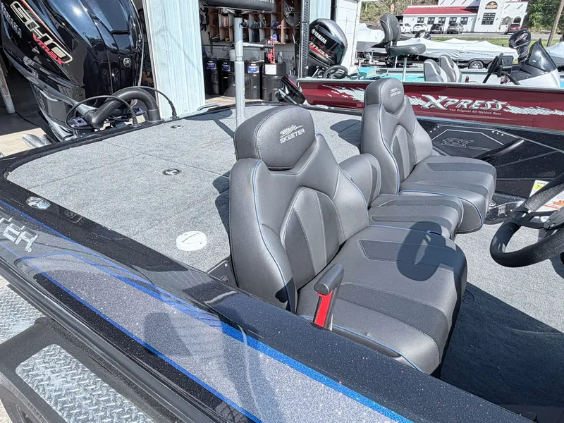 Slide: The Image of 2022 Skeeter ZX200 boat with gray seats and motor. - 27