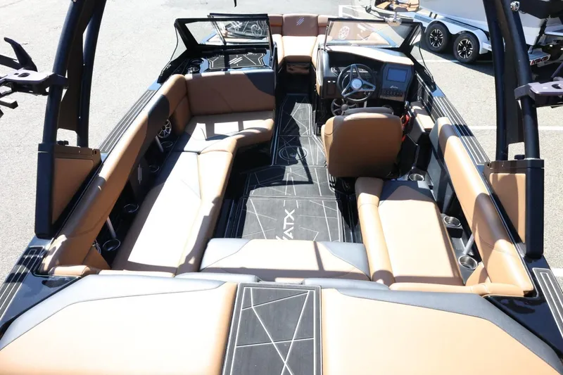 Slide: The Image of 2021 ATX Surf Boats 22 Type-S interior with tan seating and modern dashboard. - 12
