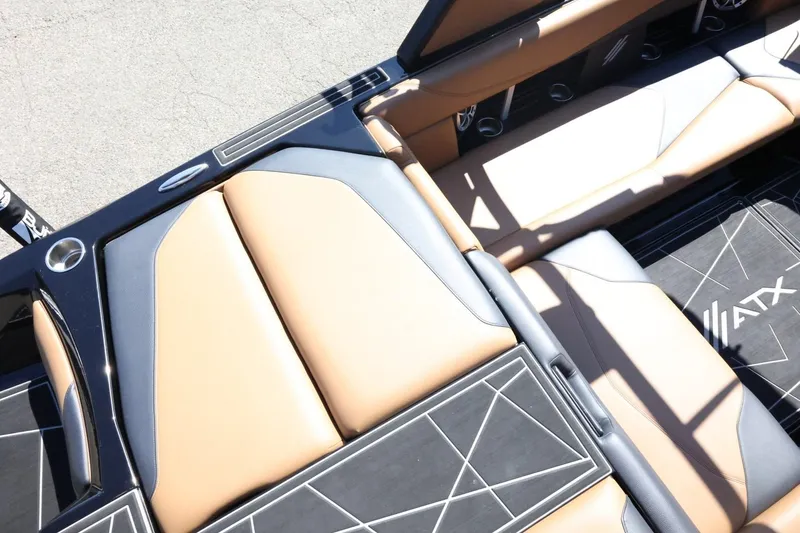Slide: The Image of 2021 ATX Surf Boats 22 Type-S interior with tan and black seating, showcasing modern design. - 13