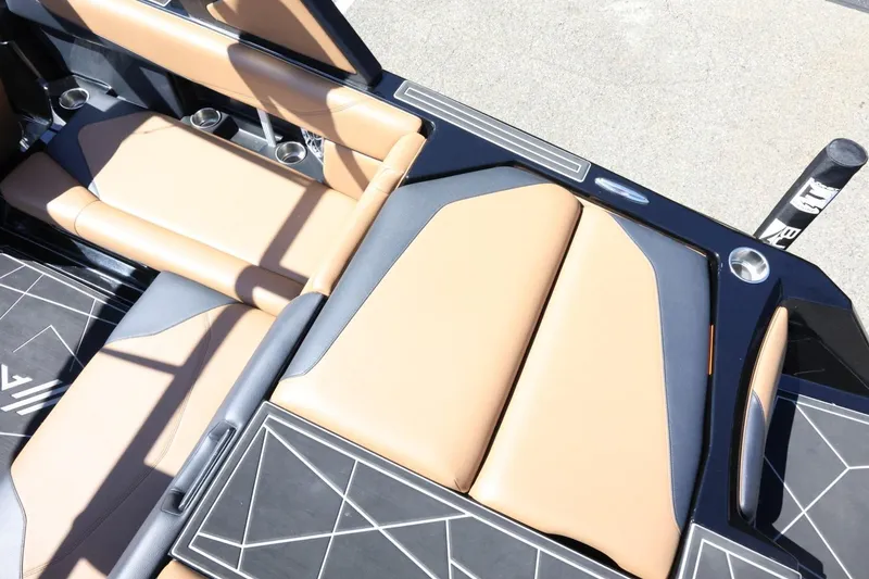 Slide: The Image of 2021 ATX Surf Boats 22 Type-S interior with tan and black seating. - 14