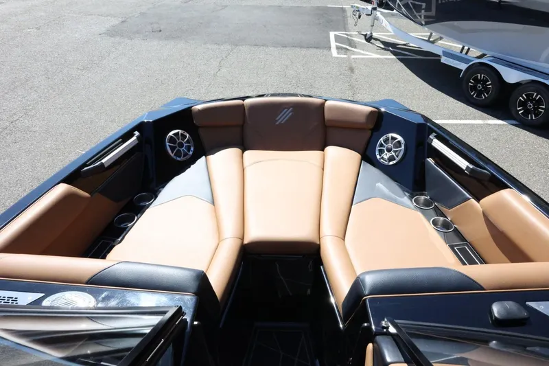 Slide: The Image of 2021 ATX Surf Boats 22 Type-S interior with tan seating and cup holders. - 18