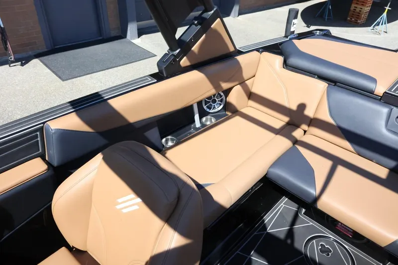 Slide: The Image of 2021 ATX Surf Boats 22 Type-S interior with tan and black seating, cup holders, and speaker. - 24