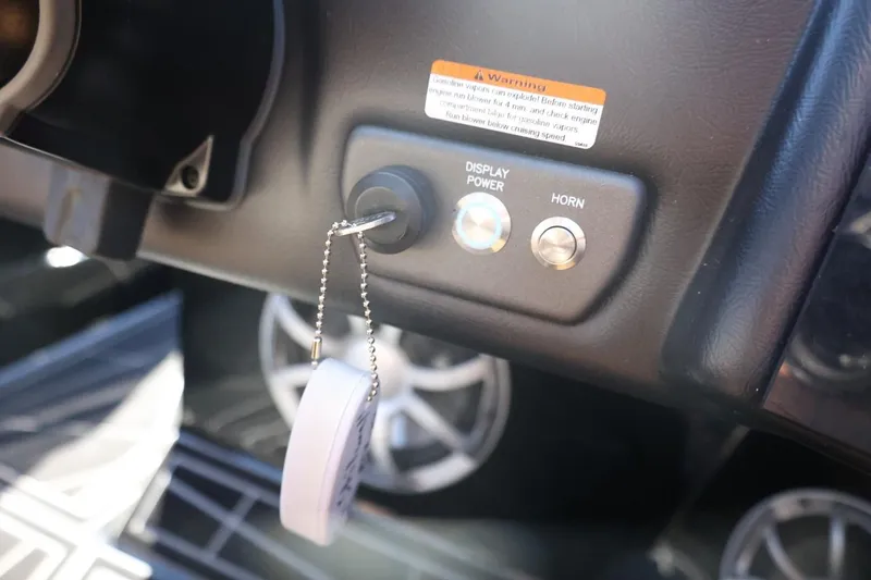 Slide: The Image of Dashboard of 2021 ATX Surf Boats 22 Type-S with key and control buttons. - 29