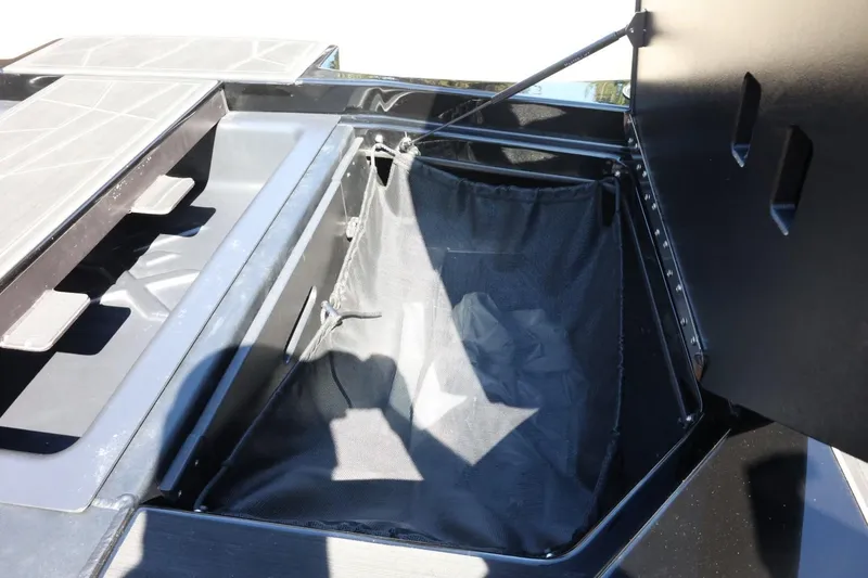 Slide: The Image of 2021 ATX Surf Boats 22 Type-S storage compartment with open lid and mesh bag. - 44