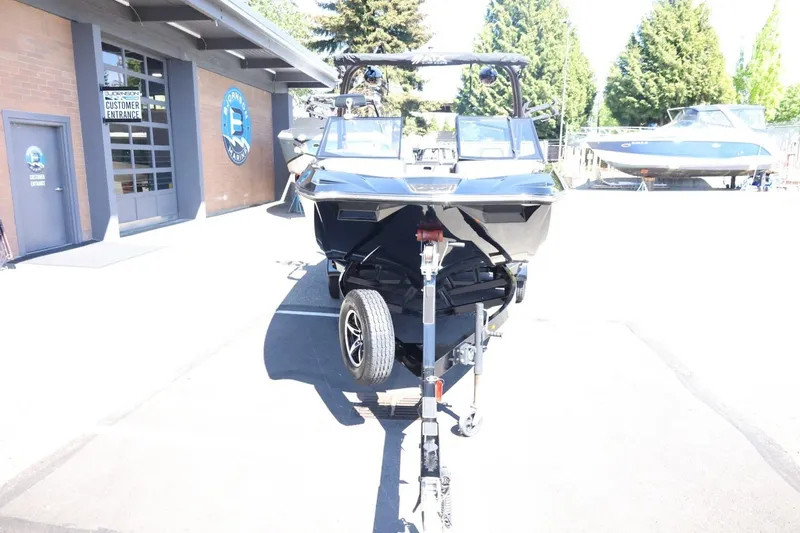 Slide: The Image of 2021 ATX Surf Boats 22 Type-S on trailer outside marina, ready for transport. - 5