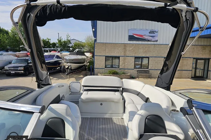Slide: The Image of 2019 Crownline 275 SS boat interior with seating, docked near showroom. - 103